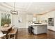 Open kitchen and dining area with stainless steel appliances and a center island with seating at 6185 Deerwoods Trl, Alpharetta, GA 30005