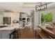 Open kitchen with stainless steel appliances, hardwood floors, and a breakfast nook with backyard views at 6185 Deerwoods Trl, Alpharetta, GA 30005