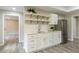 Kitchenette featuring white cabinets, quartz countertops, and stainless-steel refrigerator at 6185 Deerwoods Trl, Alpharetta, GA 30005