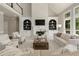 Bright living room features built-in shelving, fireplace, and large windows providing ample natural light at 6185 Deerwoods Trl, Alpharetta, GA 30005
