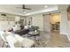 Inviting living room featuring a gray sofa, decorative pillows, and a wet bar at 6185 Deerwoods Trl, Alpharetta, GA 30005