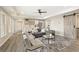 Open-concept living room boasts stylish furnishings and an adjacent kitchen area at 6185 Deerwoods Trl, Alpharetta, GA 30005