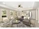 Bright living room with a large window, modern seating and decor, and an open concept layout at 6185 Deerwoods Trl, Alpharetta, GA 30005