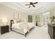 A bright main bedroom featuring tray ceiling, sitting area, and backyard views at 6185 Deerwoods Trl, Alpharetta, GA 30005