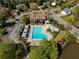 Aerial view of a community pool with a clubhouse, ample seating, and a kiddie pool at 6185 Deerwoods Trl, Alpharetta, GA 30005