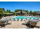 Community pool with ample seating, tables and umbrellas at 6185 Deerwoods Trl, Alpharetta, GA 30005
