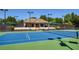 Tennis court featuring the net and clubhouse with seating in the background at 6185 Deerwoods Trl, Alpharetta, GA 30005