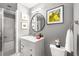 Bathroom with a glass enclosed shower, modern vanity with marble top, and a round mirror at 791 Wylie Se St # 709, Atlanta, GA 30316