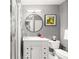 Bathroom with a glass enclosed shower, modern vanity with marble top, and a round mirror at 791 Wylie Se St # 709, Atlanta, GA 30316
