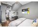 Bedroom boasts hardwood flooring and modern accents, plus an open view to the living room at 791 Wylie Se St # 709, Atlanta, GA 30316