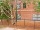 Charming brick building with black iron fence, mature trees, and well-maintained landscaping at 791 Wylie Se St # 709, Atlanta, GA 30316