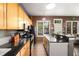 Bright kitchen features wooden cabinets, granite counters, stainless steel appliances, and bar seating at 791 Wylie Se St # 709, Atlanta, GA 30316