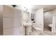 Bright bathroom featuring a pedestal sink, tiled shower, and modern fixtures at 1661 La France Ne St # 221, Atlanta, GA 30307
