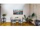 Cozy dining area features a glass table, seating for four, modern art, and a potted plant at 1661 La France Ne St # 221, Atlanta, GA 30307