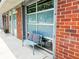 Exterior patio with comfortable seating and a charming brick wall for privacy and curb appeal at 1661 La France Ne St # 221, Atlanta, GA 30307