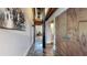 Long hallway features exposed beams, painted artwork, and stained concrete floors at 1661 La France Ne St # 221, Atlanta, GA 30307