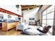 Bright, open-concept living room featuring hardwood floors and a modern kitchen with stainless steel appliances at 1661 La France Ne St # 221, Atlanta, GA 30307