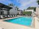 Resort-style swimming pool with lounge chairs, steel pergola, and modern architectural building at 1661 La France Ne St # 221, Atlanta, GA 30307