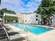 Relaxing swimming pool featuring lounge chairs, landscaped surroundings, and modern architectural building at 1661 La France Ne St # 221, Atlanta, GA 30307