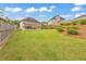 Grassy backyard featuring a small patio, landscaping and wooded fence at 197 Hickory Pointe Dr, Acworth, GA 30101