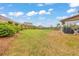 Large backyard with green lawn, tasteful landscaping and covered patio with outdoor furniture at 197 Hickory Pointe Dr, Acworth, GA 30101