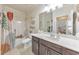 Well-lit bathroom with updated vanity, framed mirror, toilet, shower/tub, and view into another room at 197 Hickory Pointe Dr, Acworth, GA 30101
