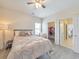 Bedroom with modern ceiling fan, plush carpet and walk-in closet access at 197 Hickory Pointe Dr, Acworth, GA 30101