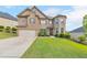 Charming two-story home with brick and tan siding, a well-manicured lawn, and an attached two-car garage at 197 Hickory Pointe Dr, Acworth, GA 30101