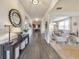 Open foyer with hardwood flooring, a decorative mirror, console table, and views of the dining and living areas at 197 Hickory Pointe Dr, Acworth, GA 30101