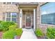 Inviting front entrance with a decorative glass door, manicured landscaping, and house number display at 197 Hickory Pointe Dr, Acworth, GA 30101
