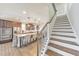 Spacious kitchen with stainless steel appliances, kitchen island, and hardwood floors next to the staircase at 197 Hickory Pointe Dr, Acworth, GA 30101