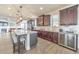 Modern kitchen with dark cabinets, stainless steel appliances, granite countertops, and an island with bar stool seating at 197 Hickory Pointe Dr, Acworth, GA 30101