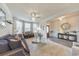 Cozy living room showcasing plush furniture, a modern chandelier, and open access to other living spaces at 197 Hickory Pointe Dr, Acworth, GA 30101