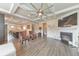 Open living room with hardwood floors, coffered ceiling, a ceiling fan, fireplace, and view into the kitchen at 197 Hickory Pointe Dr, Acworth, GA 30101