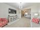Open living space featuring a TV, modern lighting, a large window, and view into the primary bedroom at 197 Hickory Pointe Dr, Acworth, GA 30101