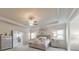 Bright primary bedroom with modern chandelier, neutral walls, and view into the primary bath at 197 Hickory Pointe Dr, Acworth, GA 30101