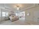 Bright primary bedroom with modern chandelier, neutral walls, and view into the living space at 197 Hickory Pointe Dr, Acworth, GA 30101
