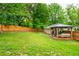 Lovely backyard with green lawn and a wooden fence, highlighted by an inviting patio with a covered seating area at 2681 Linnwood Se Dr, Smyrna, GA 30080