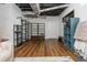 Finished basement space featuring modern vinyl flooring, exposed ductwork, and shelving for storage at 2681 Linnwood Se Dr, Smyrna, GA 30080