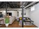 Spacious finished basement with exposed ceiling and ductwork with a cozy seating area, and tv at 2681 Linnwood Se Dr, Smyrna, GA 30080
