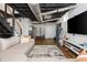 Finished basement featuring stairs and a sectional couch with media area, exposed ductwork, and painted ceiling at 2681 Linnwood Se Dr, Smyrna, GA 30080