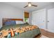 Cozy bedroom featuring a ceiling fan, natural light, and closet space, creating a serene and functional space at 2681 Linnwood Se Dr, Smyrna, GA 30080