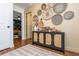 Stylish entryway boasting a decorative cabinet with unique details and woven wall decor, offering a warm welcome at 2681 Linnwood Se Dr, Smyrna, GA 30080