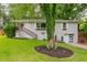 Charming painted brick home featuring a landscaped front yard and a one car garage at 2681 Linnwood Se Dr, Smyrna, GA 30080