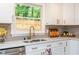 Bright kitchen features stainless steel appliances, quartz countertops, and modern faucet, making it both beautiful and efficient at 2681 Linnwood Se Dr, Smyrna, GA 30080