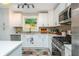 Modern kitchen with stainless steel appliances, white cabinets, and stylish decor creates a functional and inviting cooking space at 2681 Linnwood Se Dr, Smyrna, GA 30080