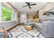 Bright living room with hardwood floors, a large sectional sofa, and stylish decor with a view of the kitchen at 2681 Linnwood Se Dr, Smyrna, GA 30080