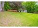 Sprawling green lawn slopes down toward a charming home featuring a freshly painted brick exterior at 2681 Linnwood Se Dr, Smyrna, GA 30080
