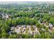 Lush community view showing homes nestled among green trees; showcases neighborhood layout at 320 Rossiter Rdg, Alpharetta, GA 30022