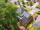 Aerial view featuring a house with dark roof, leafy trees, and landscaped backyard at 320 Rossiter Rdg, Alpharetta, GA 30022